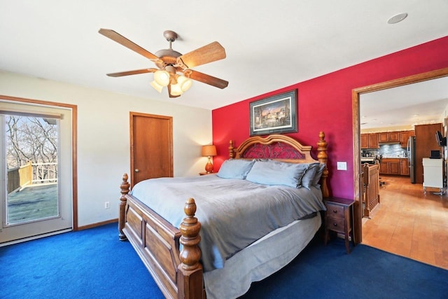 bedroom featuring access to exterior, baseboards, ceiling fan, freestanding refrigerator, and light wood-style floors