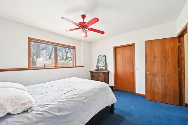 carpeted bedroom with baseboards and a ceiling fan