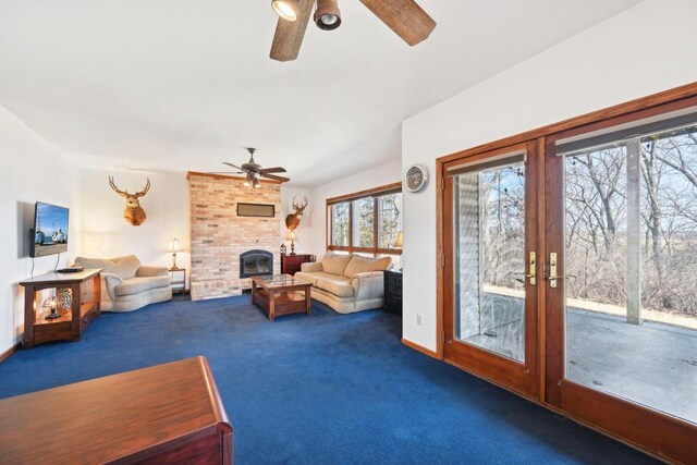 living room with a fireplace, a ceiling fan, french doors, and carpet floors