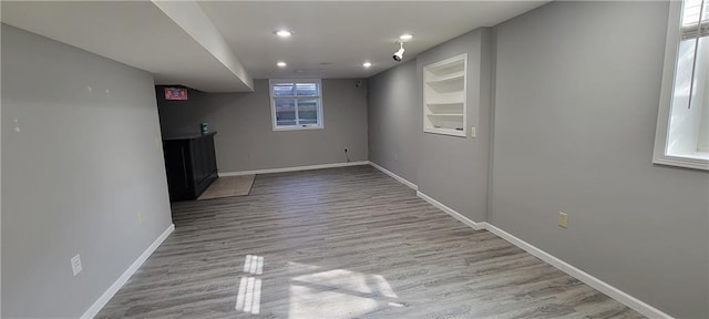 interior space with recessed lighting, baseboards, and wood finished floors