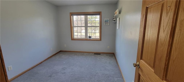 spare room with carpet and baseboards