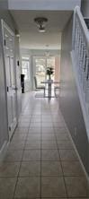 hallway featuring tile patterned flooring