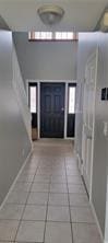 interior space featuring tile patterned flooring and baseboards