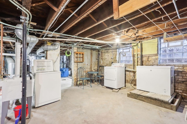 basement featuring washer and dryer and fridge