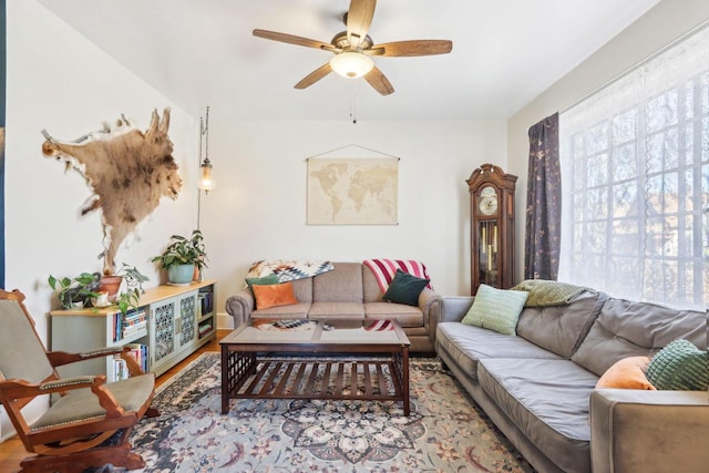 living area featuring wood finished floors and a ceiling fan