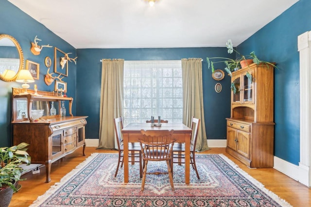 dining area featuring baseboards and light wood-style floors