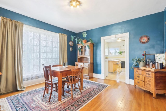 dining area featuring baseboards and light wood-style floors