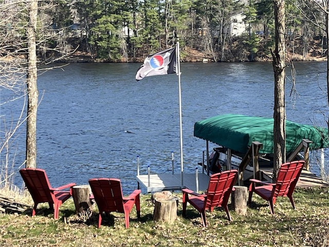 dock area featuring a forest view and a water view