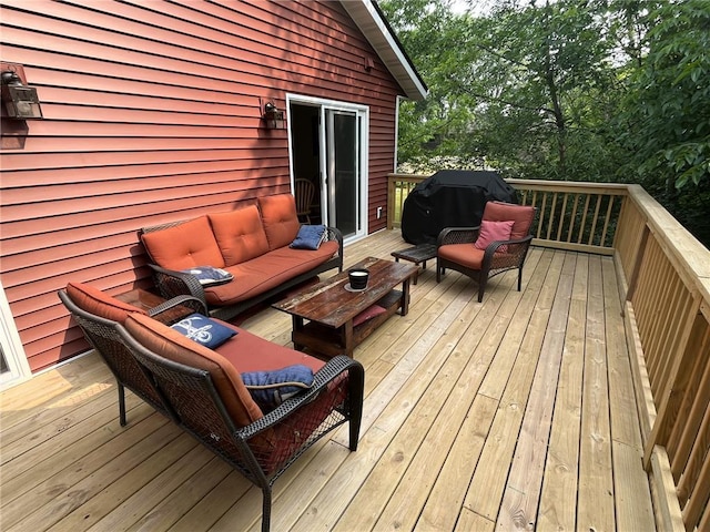 wooden terrace featuring a grill and an outdoor hangout area