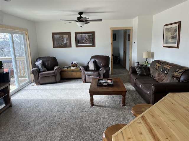 living area with ceiling fan and carpet floors