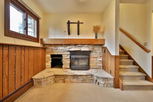 living room with stairway, baseboard heating, and a fireplace