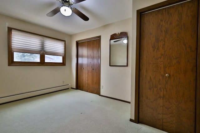 unfurnished bedroom with a baseboard heating unit, light carpet, a ceiling fan, and baseboards