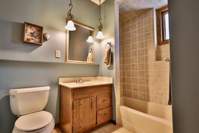 full bath with toilet,  shower combination, and vanity