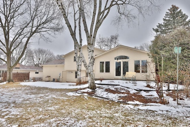 view of snow covered back of property