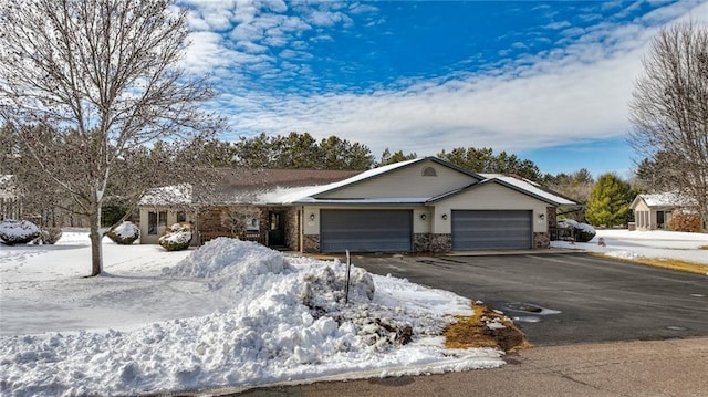 ranch-style house with aphalt driveway and an attached garage