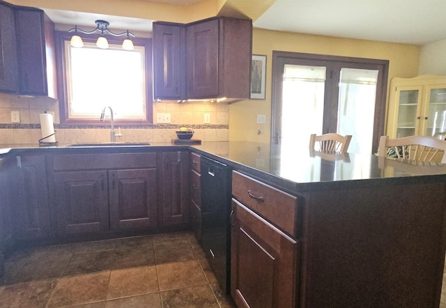 kitchen with black dishwasher, a peninsula, a sink, french doors, and backsplash