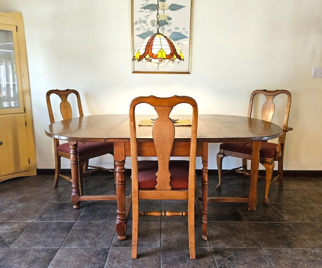 dining area featuring baseboards