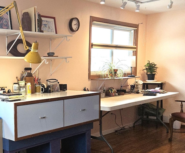 home office with rail lighting and wood finished floors