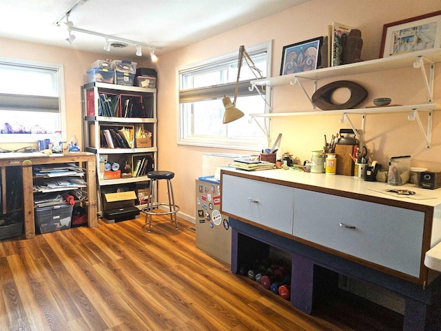 interior space featuring baseboards and wood finished floors