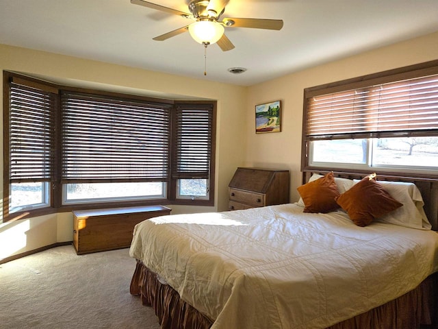 bedroom featuring a ceiling fan, carpet, visible vents, and baseboards