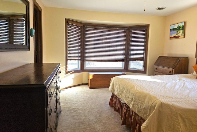 bedroom with carpet, visible vents, and baseboards