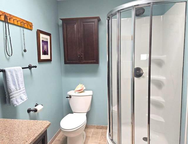 full bathroom featuring tile patterned floors, a shower stall, toilet, and vanity