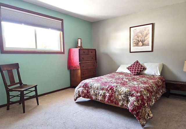 carpeted bedroom featuring baseboards