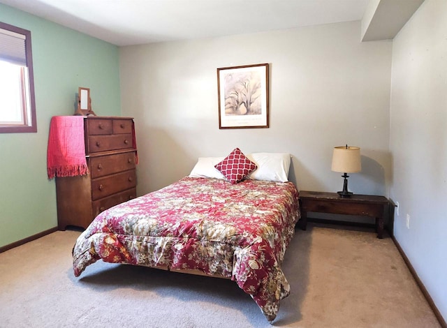 bedroom featuring carpet floors and baseboards