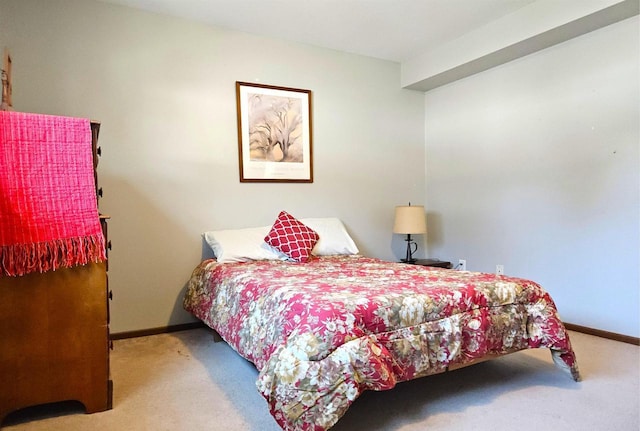 carpeted bedroom featuring baseboards