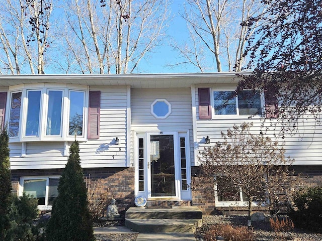 view of front facade featuring entry steps and brick siding