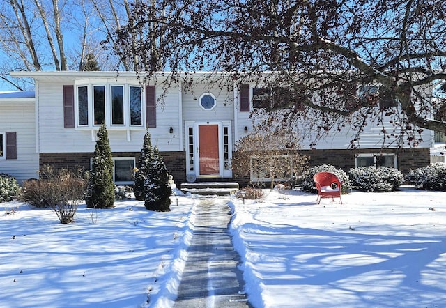 raised ranch featuring brick siding