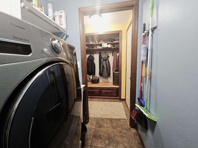 washroom with laundry area and washer / dryer