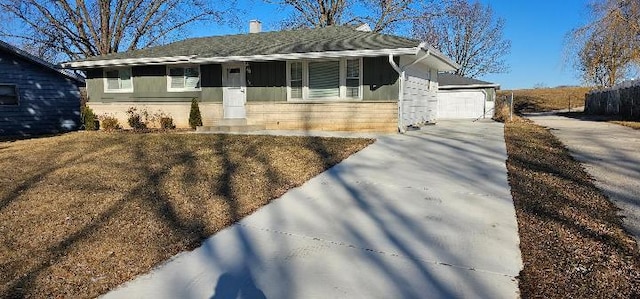 single story home featuring a garage and brick siding