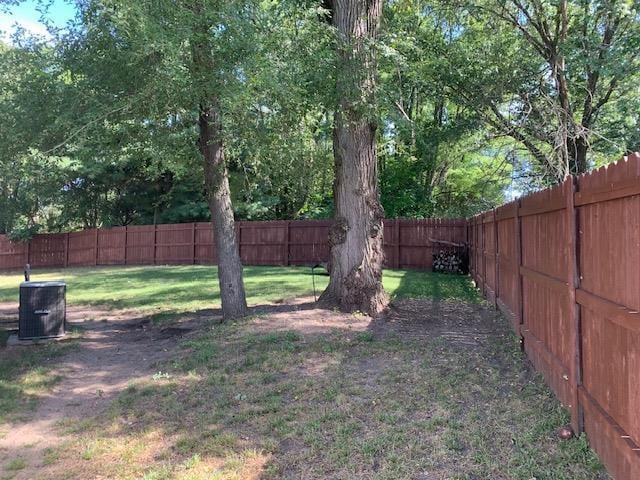 view of yard with cooling unit and a fenced backyard