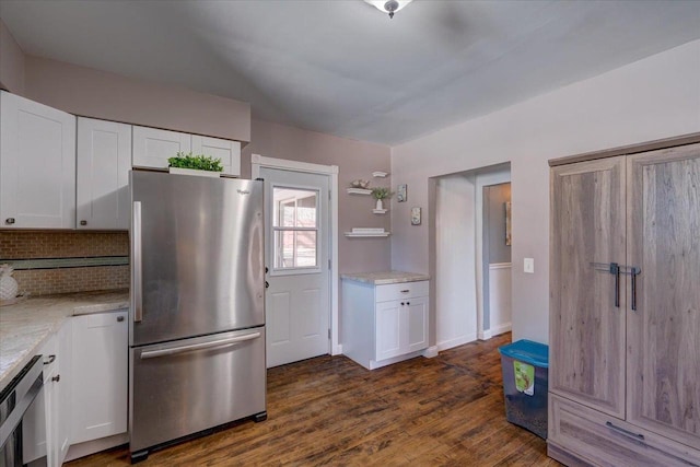 kitchen featuring white cabinets, dark wood-style flooring, and freestanding refrigerator