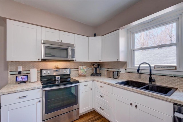 kitchen featuring a sink, white cabinetry, appliances with stainless steel finishes, and light countertops