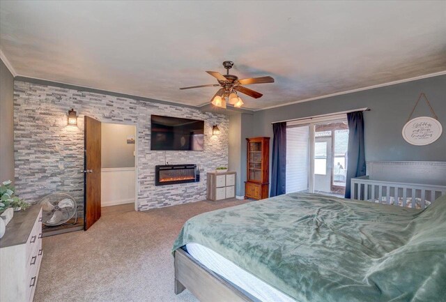 carpeted bedroom featuring crown molding, a fireplace, and ceiling fan