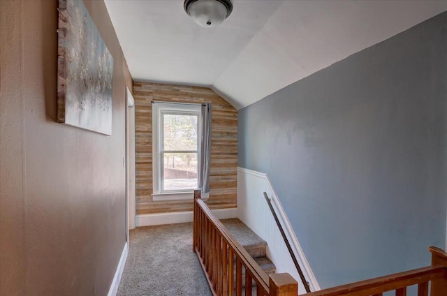 interior space featuring carpet flooring, baseboards, and vaulted ceiling