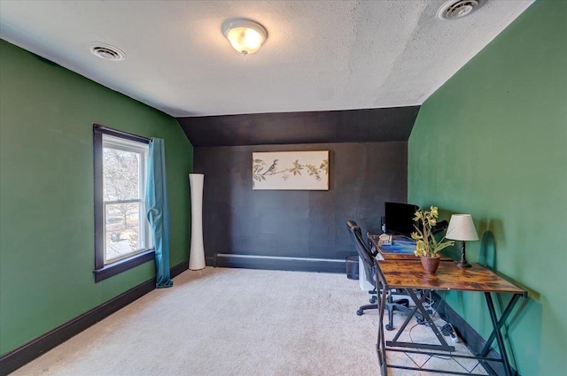 carpeted office space with visible vents, a textured ceiling, baseboards, and lofted ceiling