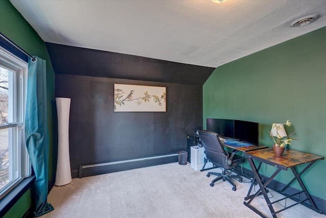 office area with lofted ceiling, visible vents, carpet floors, and a textured ceiling