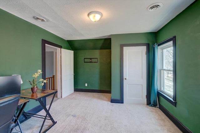 office area featuring visible vents, baseboards, and light colored carpet