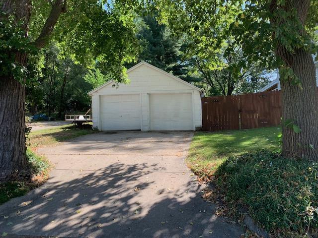 detached garage featuring fence