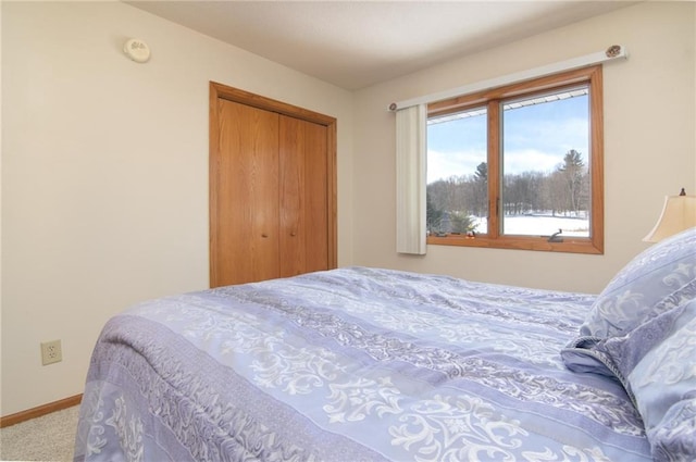 bedroom featuring a closet, carpet flooring, and baseboards