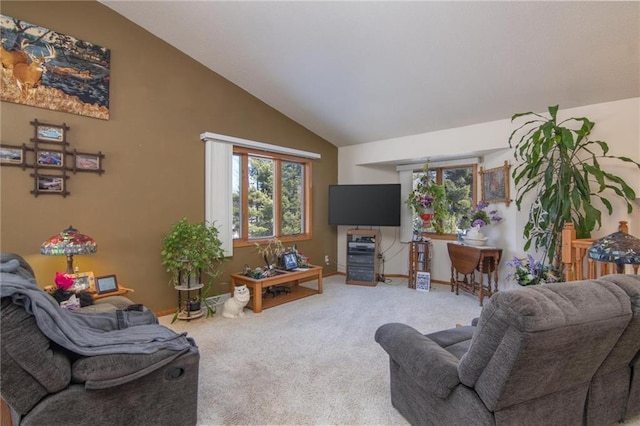 carpeted living area featuring vaulted ceiling and baseboards