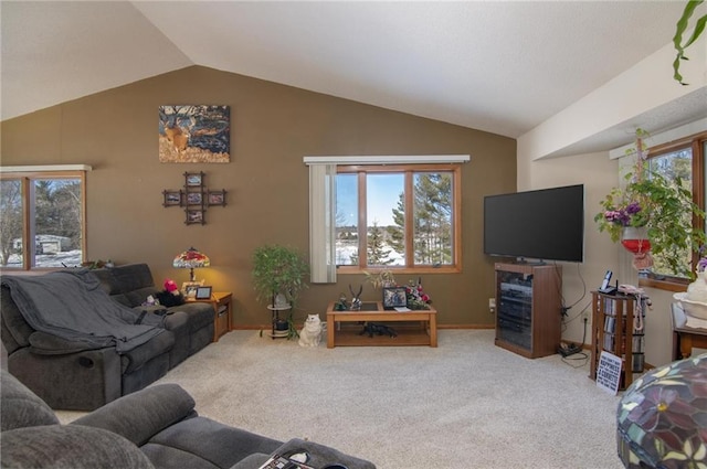 living area featuring vaulted ceiling, carpet flooring, and baseboards