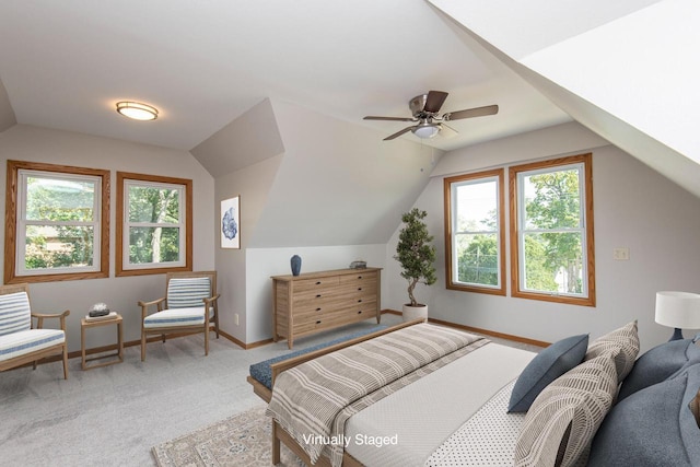 carpeted bedroom with vaulted ceiling and baseboards