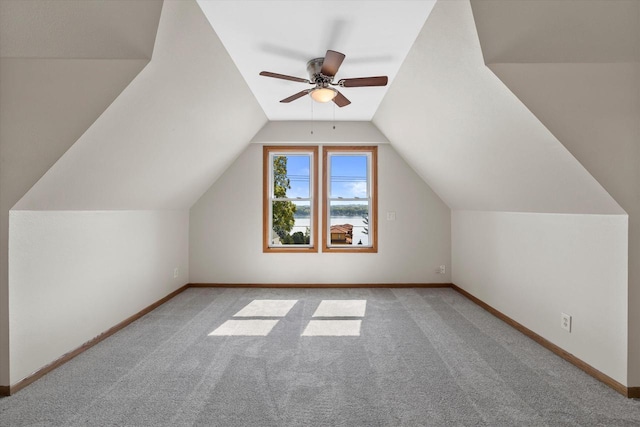 bonus room with carpet floors, baseboards, vaulted ceiling, and a ceiling fan