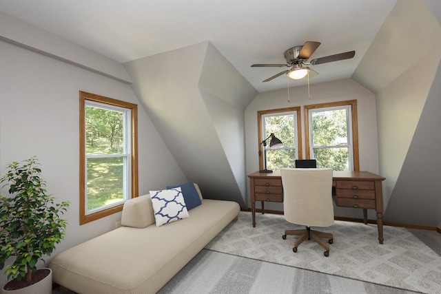 carpeted office space with lofted ceiling, ceiling fan, and baseboards