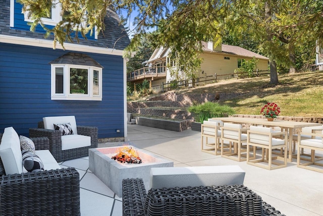 view of patio featuring an outdoor living space with a fire pit and outdoor dining space