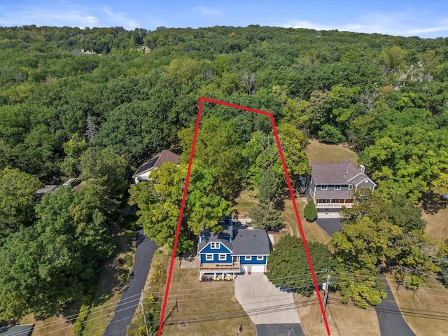 birds eye view of property with a wooded view